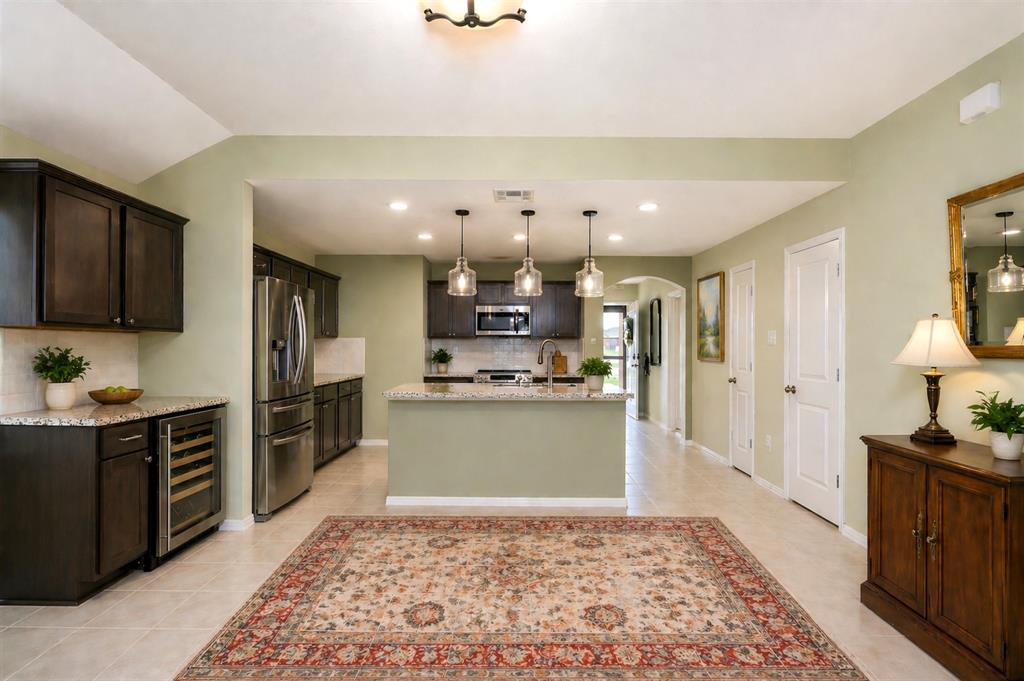 910 Community Way Royse City, TX 75189 - Photo 3 of 27 a kitchen with kitchen island granite countertop lots of counter top space and stainless steel appliances