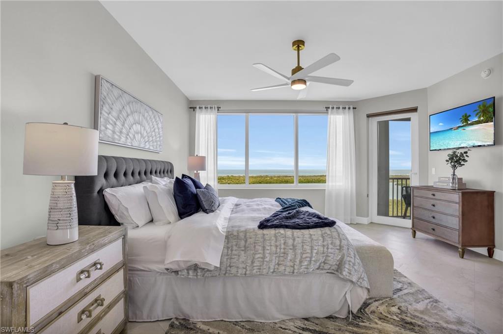 265 Indies Way, Unit 1402 Naples, FL 34110 - Photo 2 of 45 Bedroom with access to outside and ceiling fan