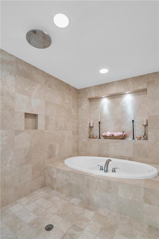 265 Indies Way, Unit 1402 Naples, FL 34110 - Photo 33 of 45 Bathroom featuring tile floors, shower with separate bathtub, and tile walls