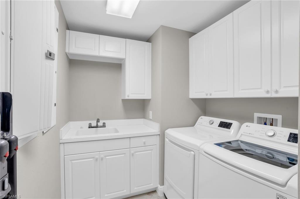 265 Indies Way, Unit 1402 Naples, FL 34110 - Photo 40 of 45 Laundry room with hookup for a washing machine, sink, separate washer and dryer, and cabinets