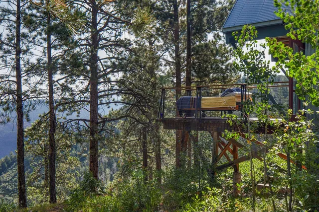 a balcony with chairs and a table