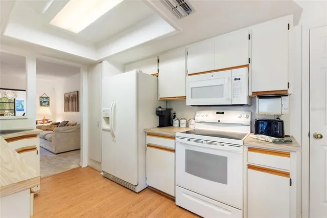 a bedroom with a large bed and wooden floor