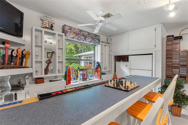 a dining room with furniture a flat screen tv and outdoor view