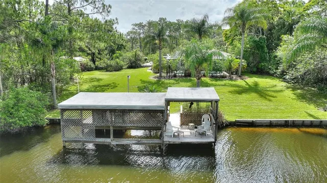 a view of pool with sitting area and lake view