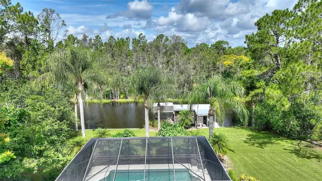 a room with lots of furniture and view of kitchen