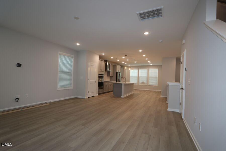 2913 Richardson Road, Unit 475 Apex, NC 27502 - Photo 7 of 24 a view of empty room with wooden floor
