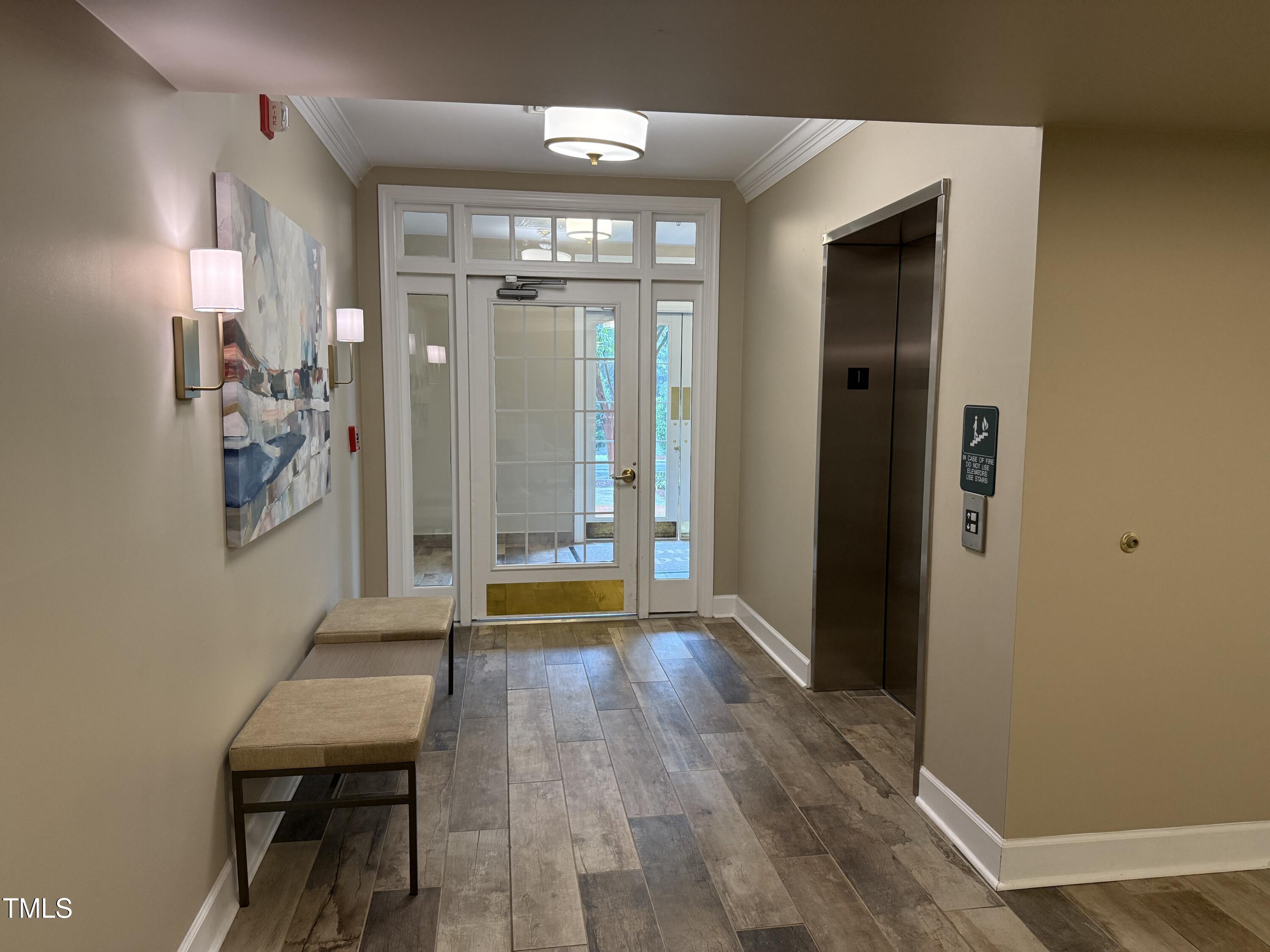 108-201 Northbrook Drive Raleigh, NC 27609 - Photo 14 of 32 a view of a hallway with wooden floor and dining room
