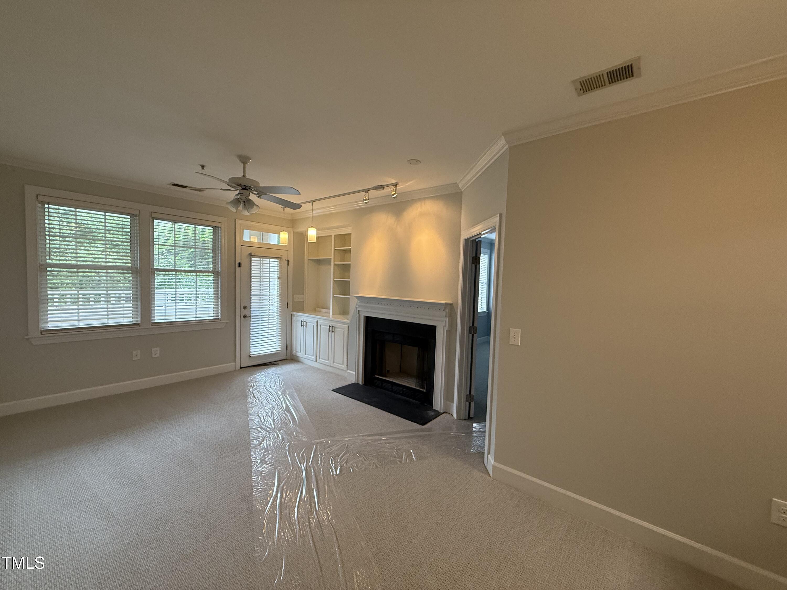 108-201 Northbrook Drive Raleigh, NC 27609 - Photo 19 of 32 an empty room with windows and fireplace