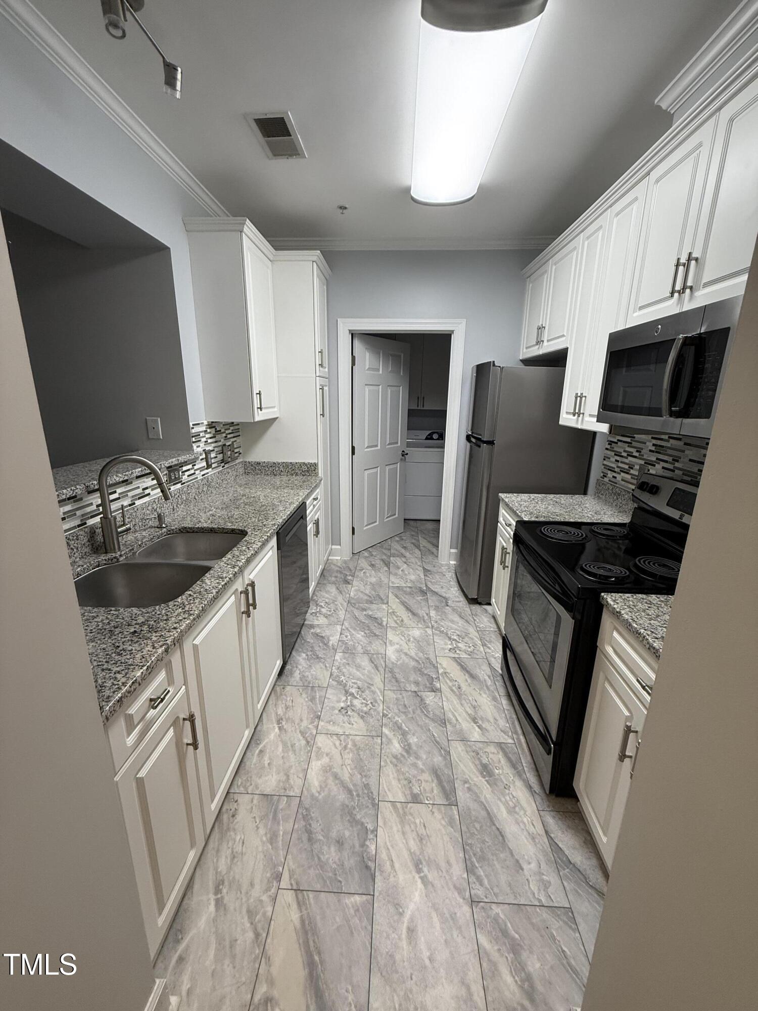 108-201 Northbrook Drive Raleigh, NC 27609 - Photo 21 of 32 a kitchen with granite countertop a sink stove and refrigerator