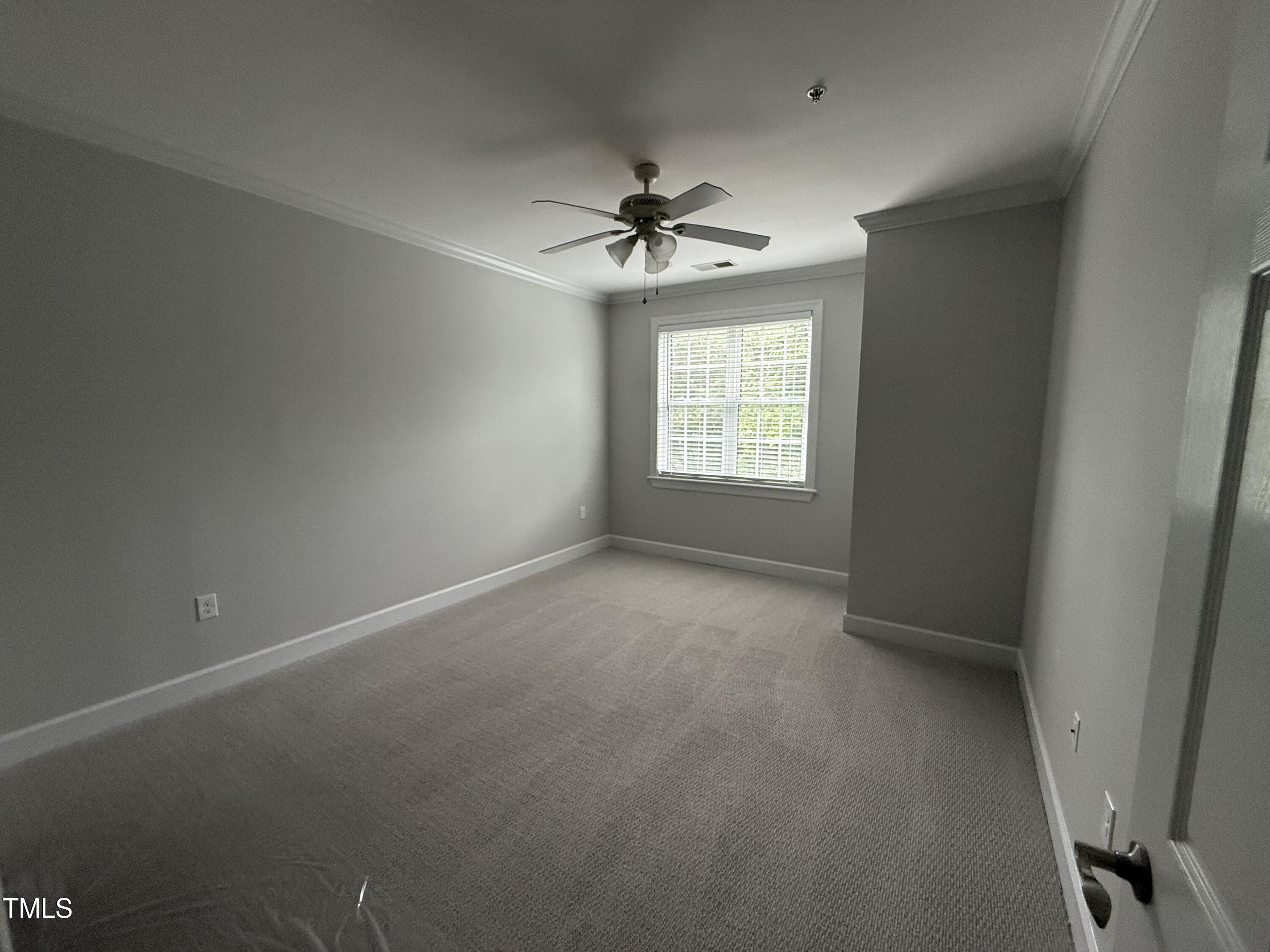 108-201 Northbrook Drive Raleigh, NC 27609 - Photo 24 of 32 an empty room with windows and ceiling fan