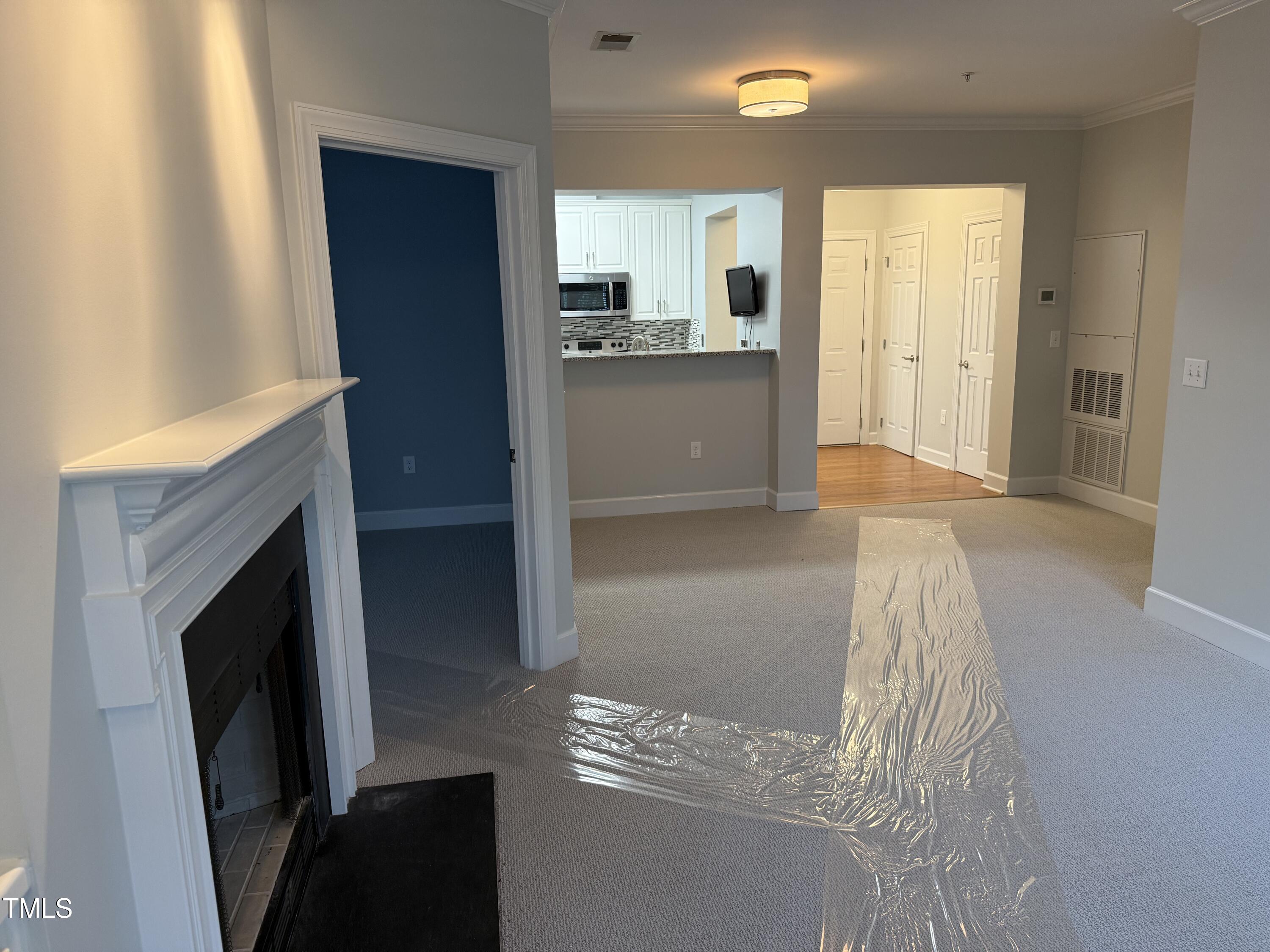 108-201 Northbrook Drive Raleigh, NC 27609 - Photo 30 of 32 a view of a kitchen cabinets and a fireplace