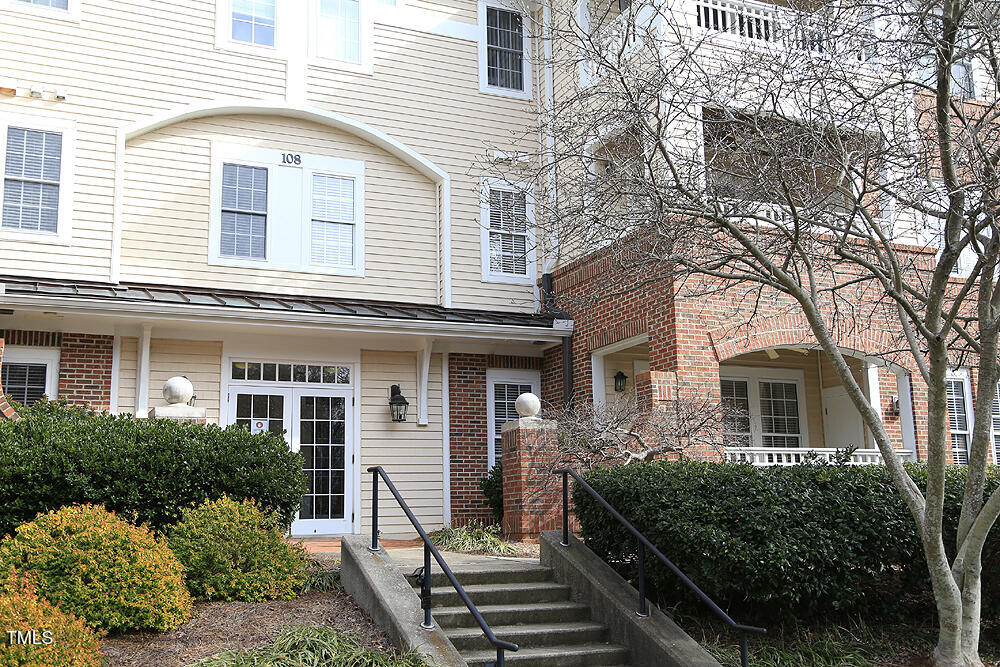 108-201 Northbrook Drive Raleigh, NC 27609 - Photo 3 of 32 a front view of a house with a garden