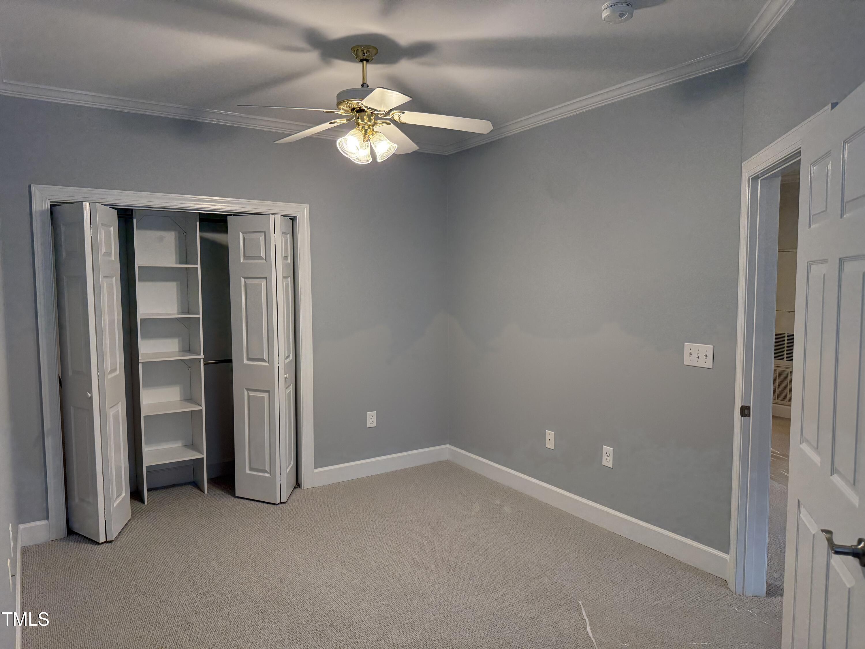 108-201 Northbrook Drive Raleigh, NC 27609 - Photo 31 of 32 an empty room with chandelier fan