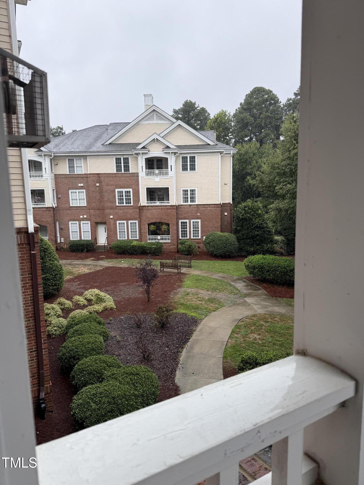 108-201 Northbrook Drive Raleigh, NC 27609 - Photo 4 of 32 a front view of a house with garden