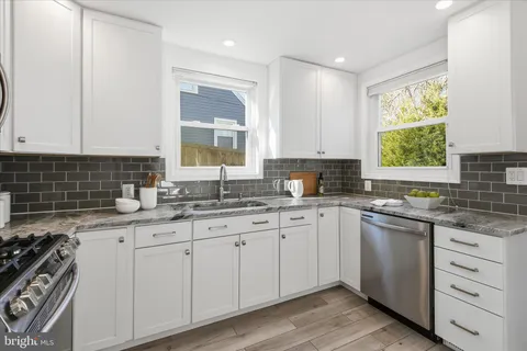 a kitchen with stainless steel appliances a stove a microwave and a refrigerator