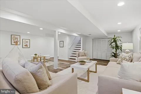 a view of a brick house with a large windows and flower plants
