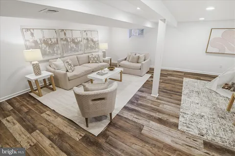 a front view of house with yard and trees around