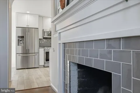 a kitchen with granite countertop cabinets stainless steel appliances a sink and a window