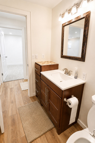 1055 North 1000 East Mapleton, UT 84664 - Photo 64 of 112 Bathroom featuring wood-finish flooring and a dark wood vanity with a white countertop and integrated sink