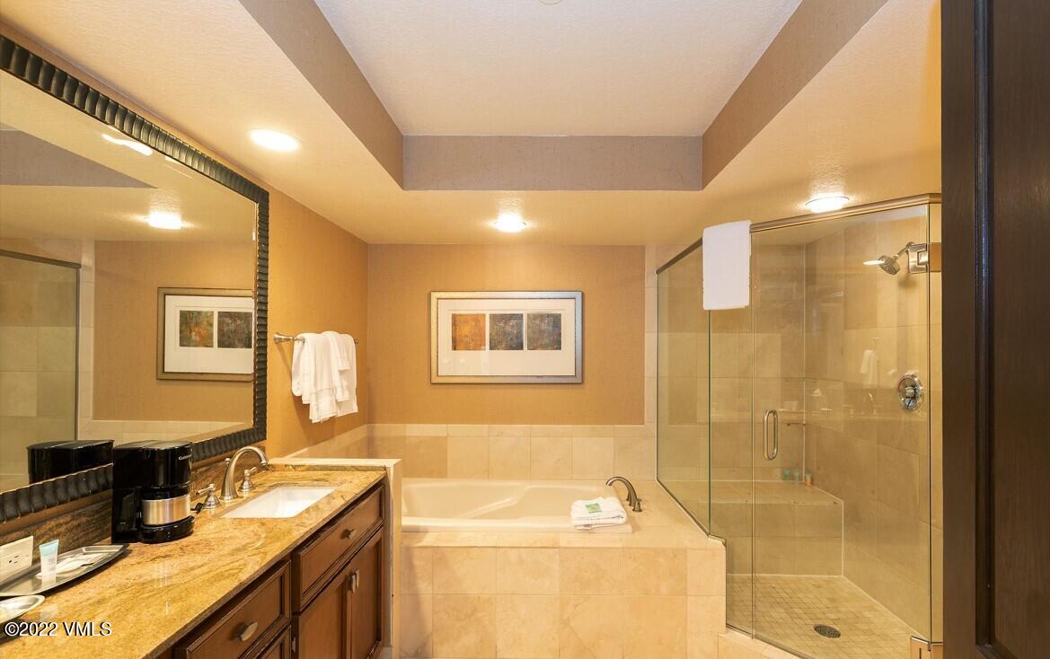 210 Offerson Road, Unit R421 / WEEK 47 Beaver Creek, CO 81620 - Photo 11 of 20 a bathroom with a granite countertop sink a mirror a bathtub and shower