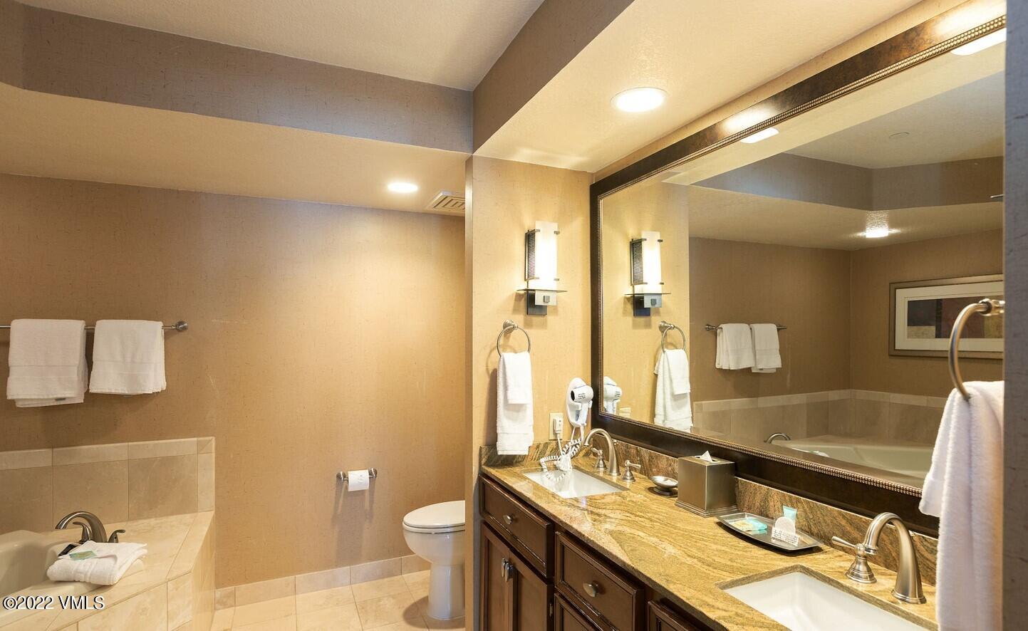 210 Offerson Road, Unit R421 / WEEK 47 Beaver Creek, CO 81620 - Photo 20 of 20 a bathroom with a granite countertop sink a toilet a mirror and shower