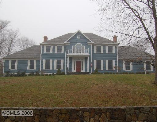 15 Pepperbush Road Weston, CT 06883 - Photo 1 of 1 a front view of a house with a garden