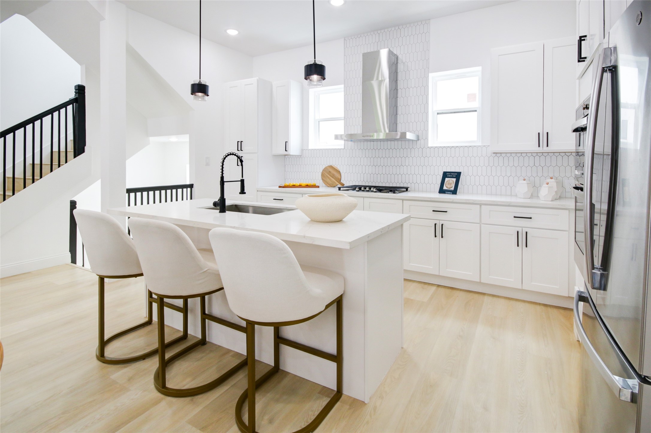 1214 West 24th Street, Unit A Houston, TX 77008 - Photo 14 of 45 a kitchen with stainless steel appliances granite countertop a table chairs sink and cabinets