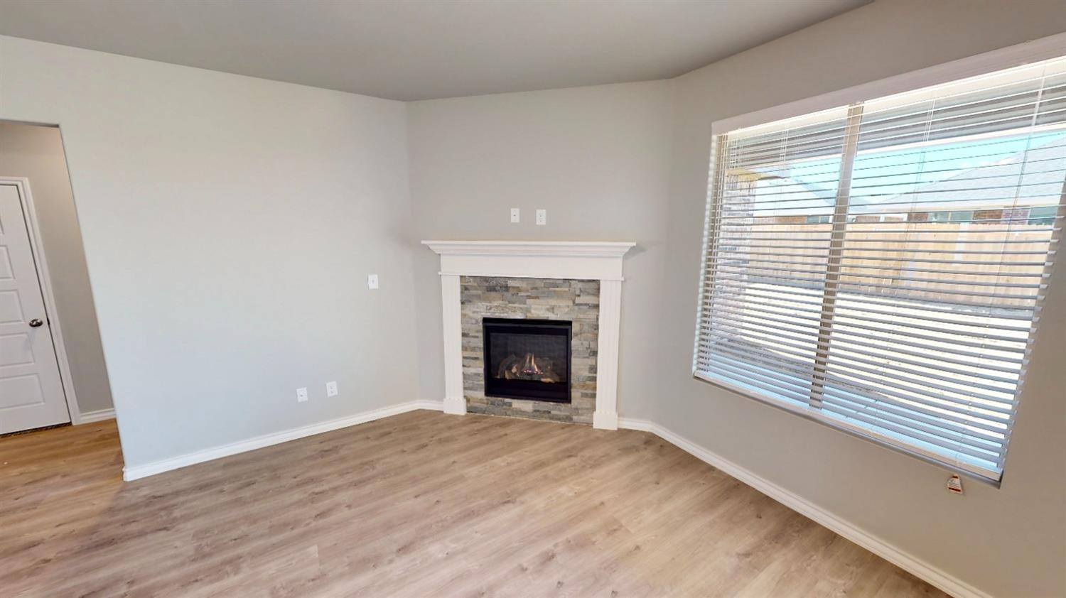 5804 Waverly Lubbock, TX 79407 - Photo 12 of 26 a view of an empty room with a window and fireplace