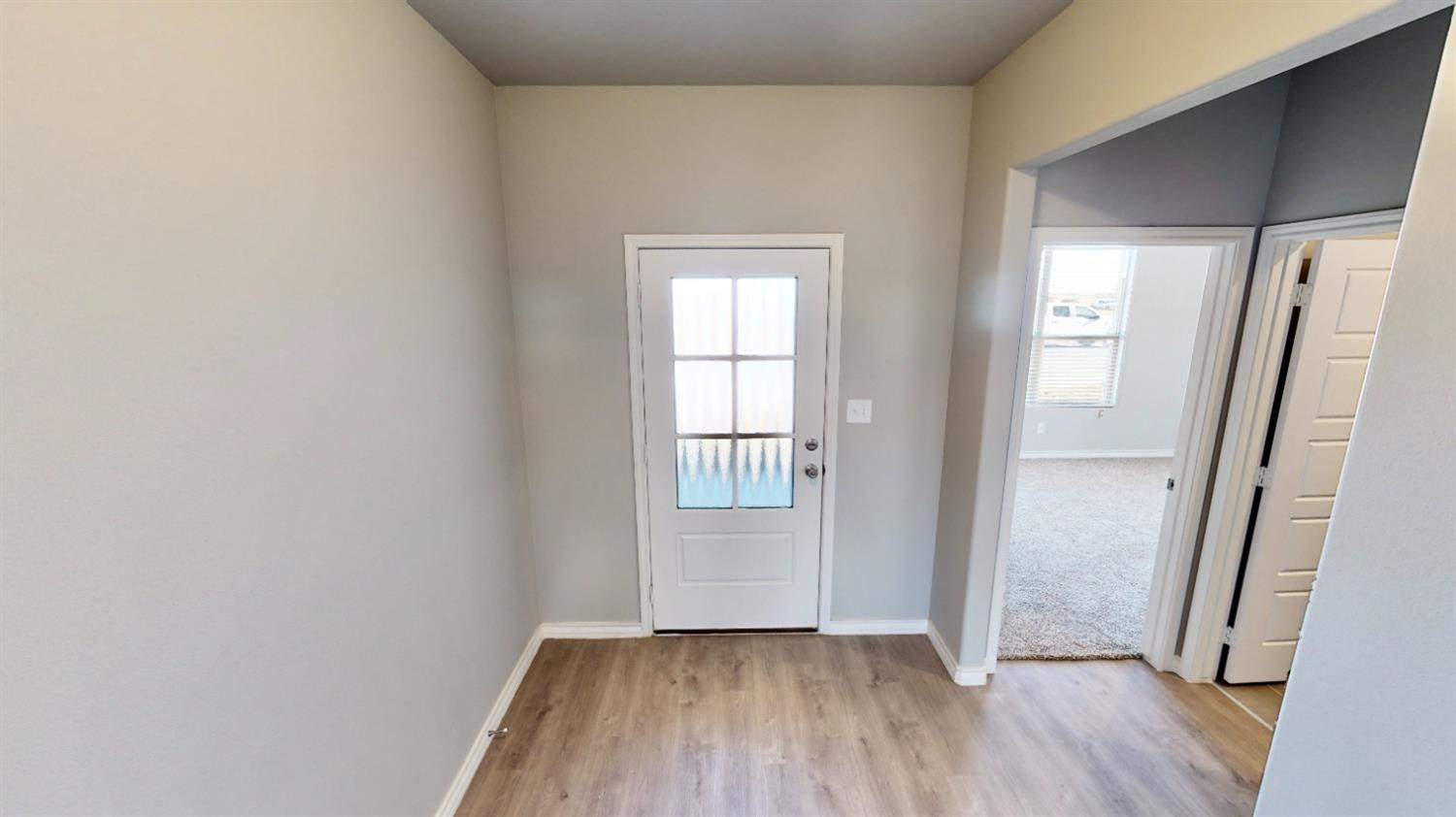 5804 Waverly Lubbock, TX 79407 - Photo 9 of 26 an empty room with wooden floor and windows