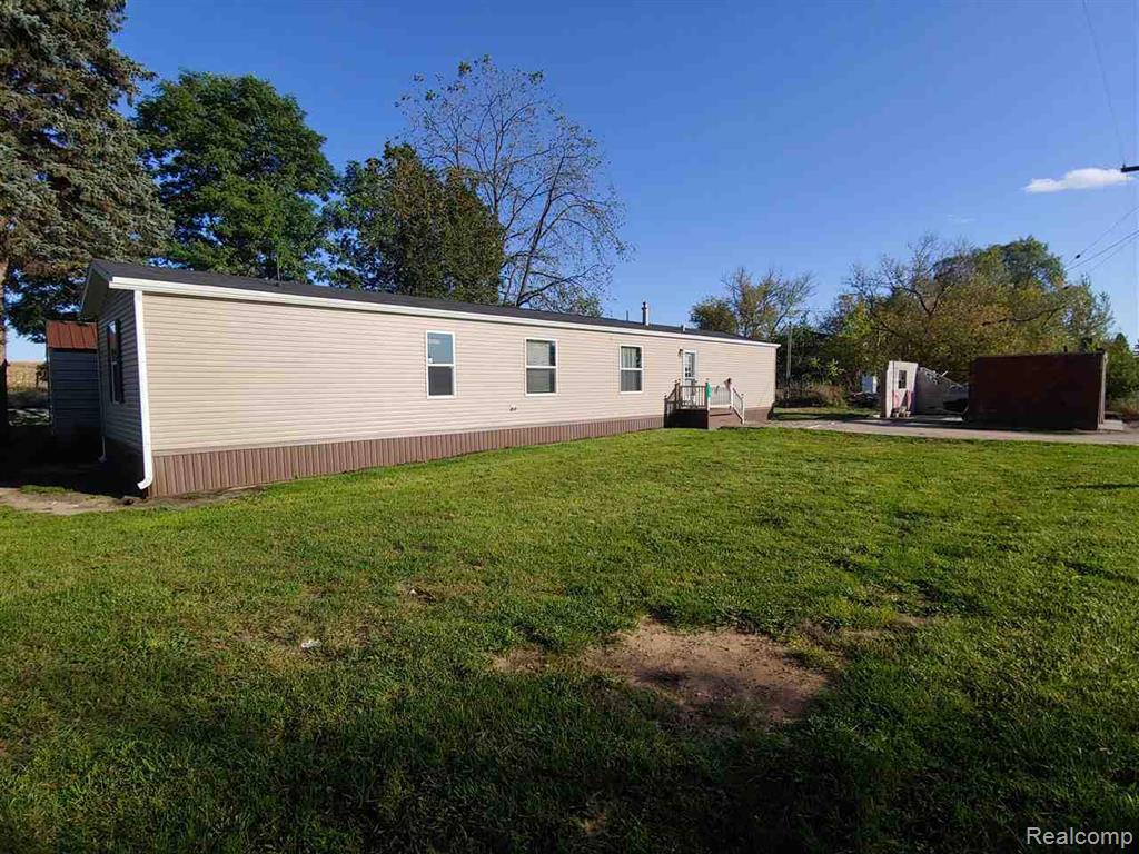 121 Haskin Street Boon, MI 49618 - Photo 1 of 13 Back of house with a yard