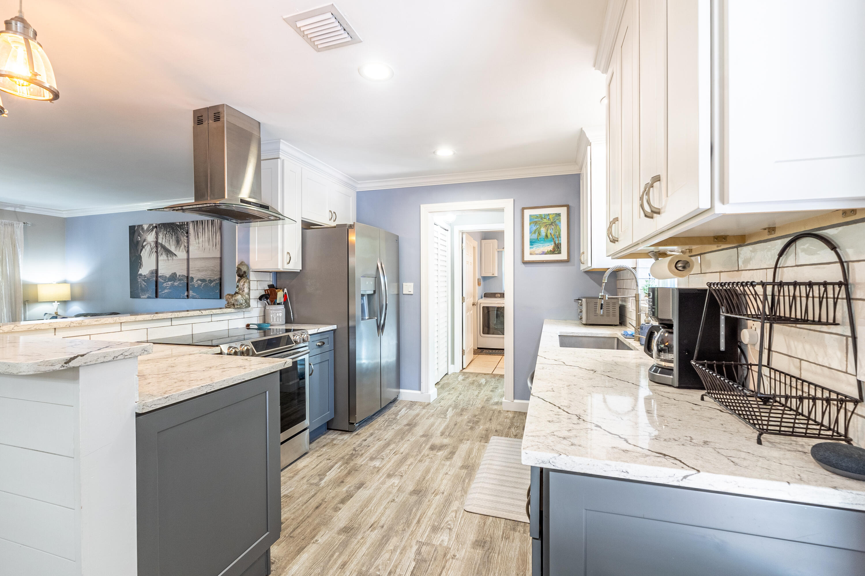 400 Pittsburgh Drive Jupiter, FL 33458 - Photo 5 of 30 a large kitchen with stainless steel appliances kitchen island granite countertop a refrigerator oven stove a sink and dishwasher