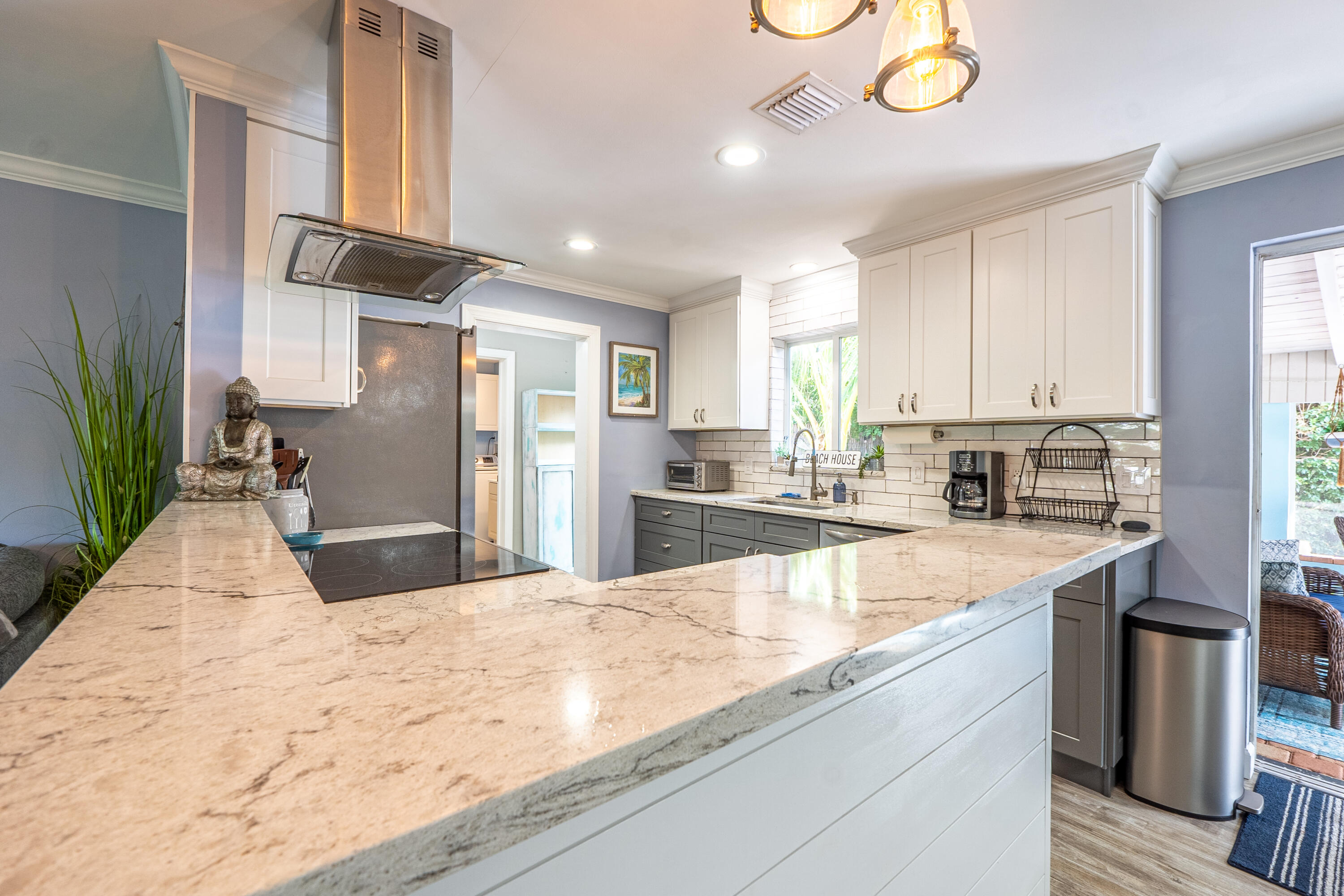 400 Pittsburgh Drive Jupiter, FL 33458 - Photo 6 of 30 a large kitchen with kitchen island a large counter top space a sink stainless steel appliances and cabinets