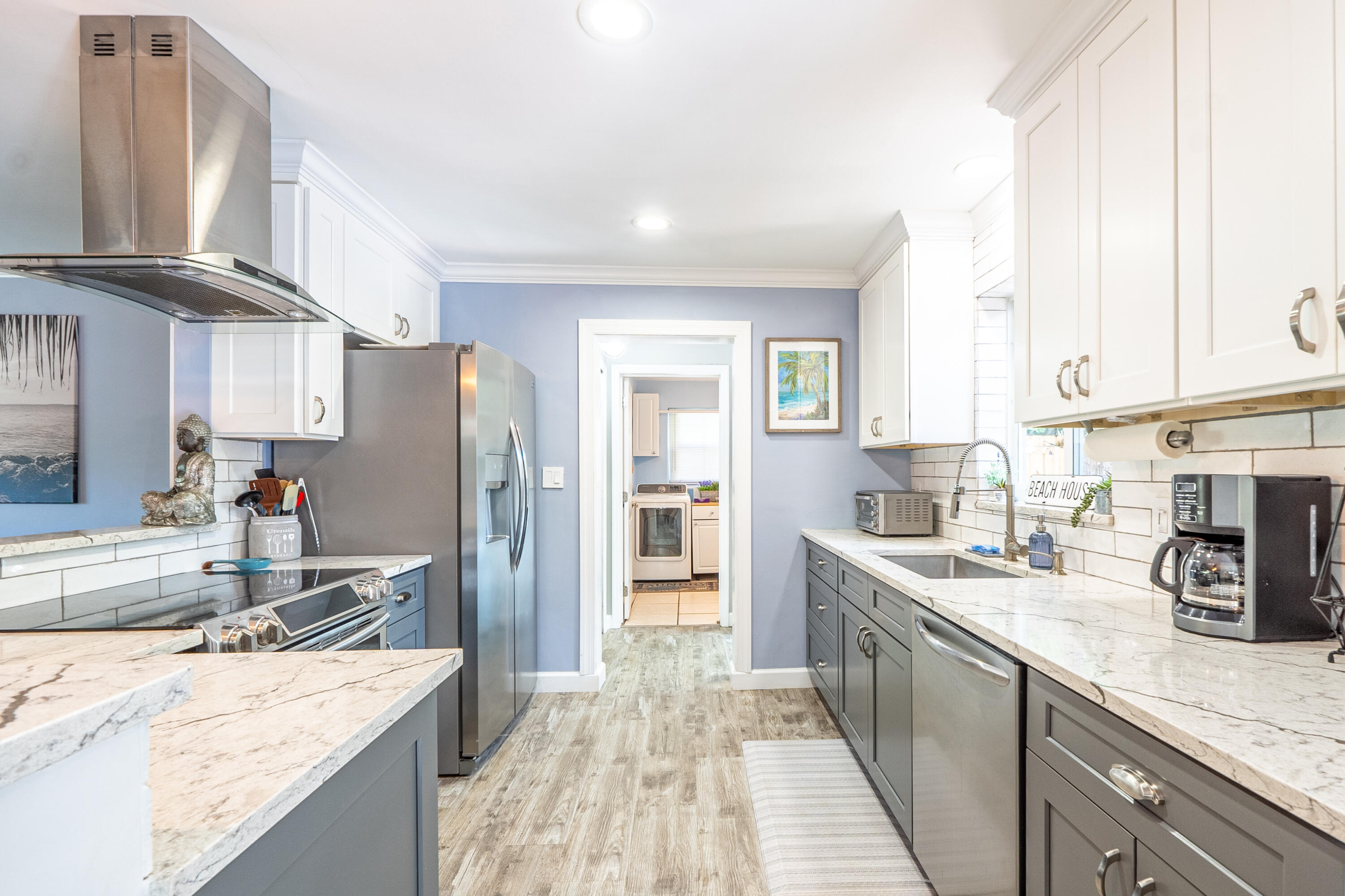 400 Pittsburgh Drive Jupiter, FL 33458 - Photo 7 of 30 a kitchen with stainless steel appliances granite countertop a sink stove and refrigerator