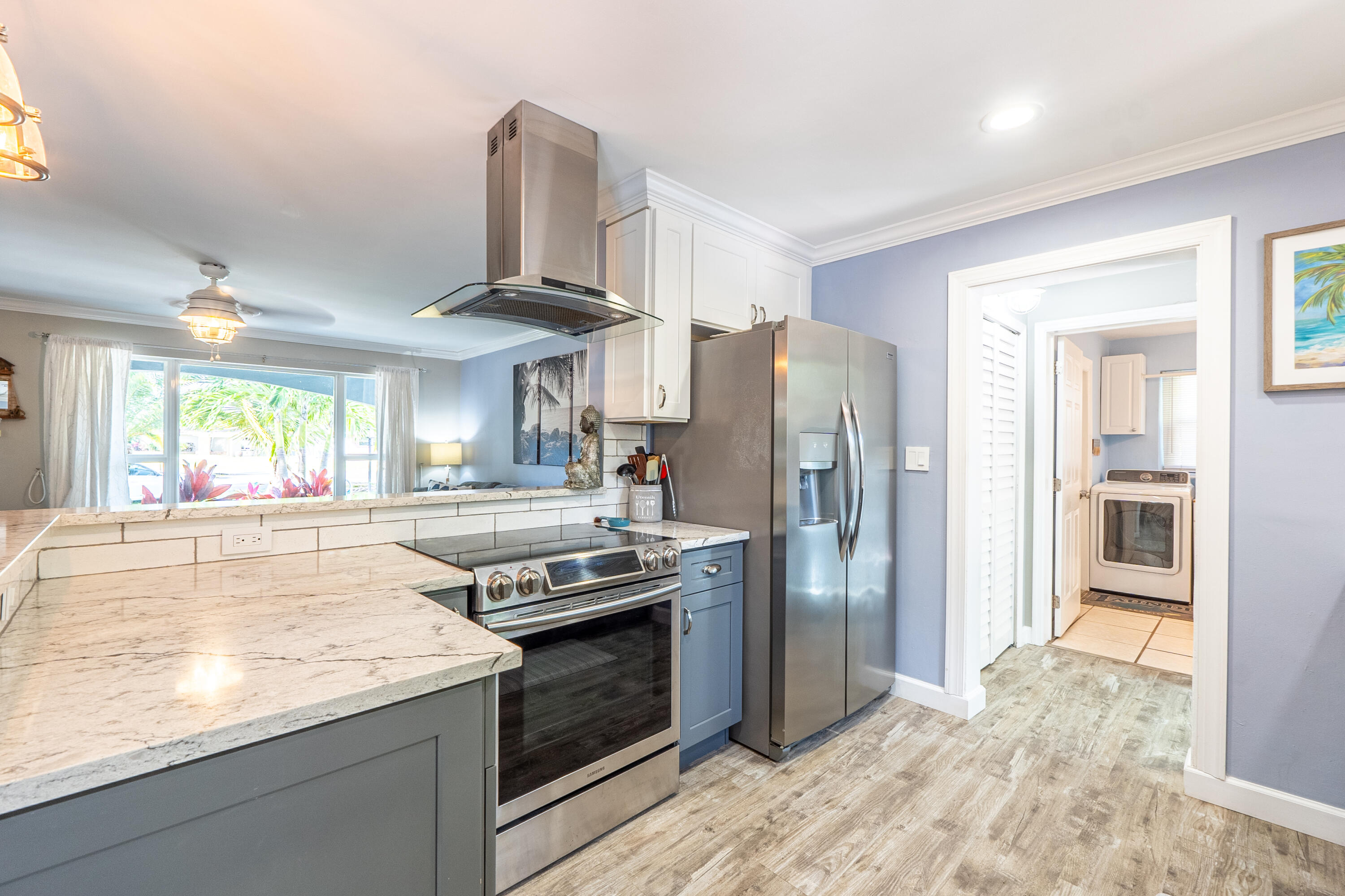 400 Pittsburgh Drive Jupiter, FL 33458 - Photo 8 of 30 a kitchen with stainless steel appliances granite countertop a refrigerator a stove and a sink