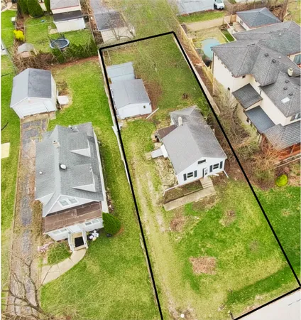 an aerial view of a house with a swimming pool