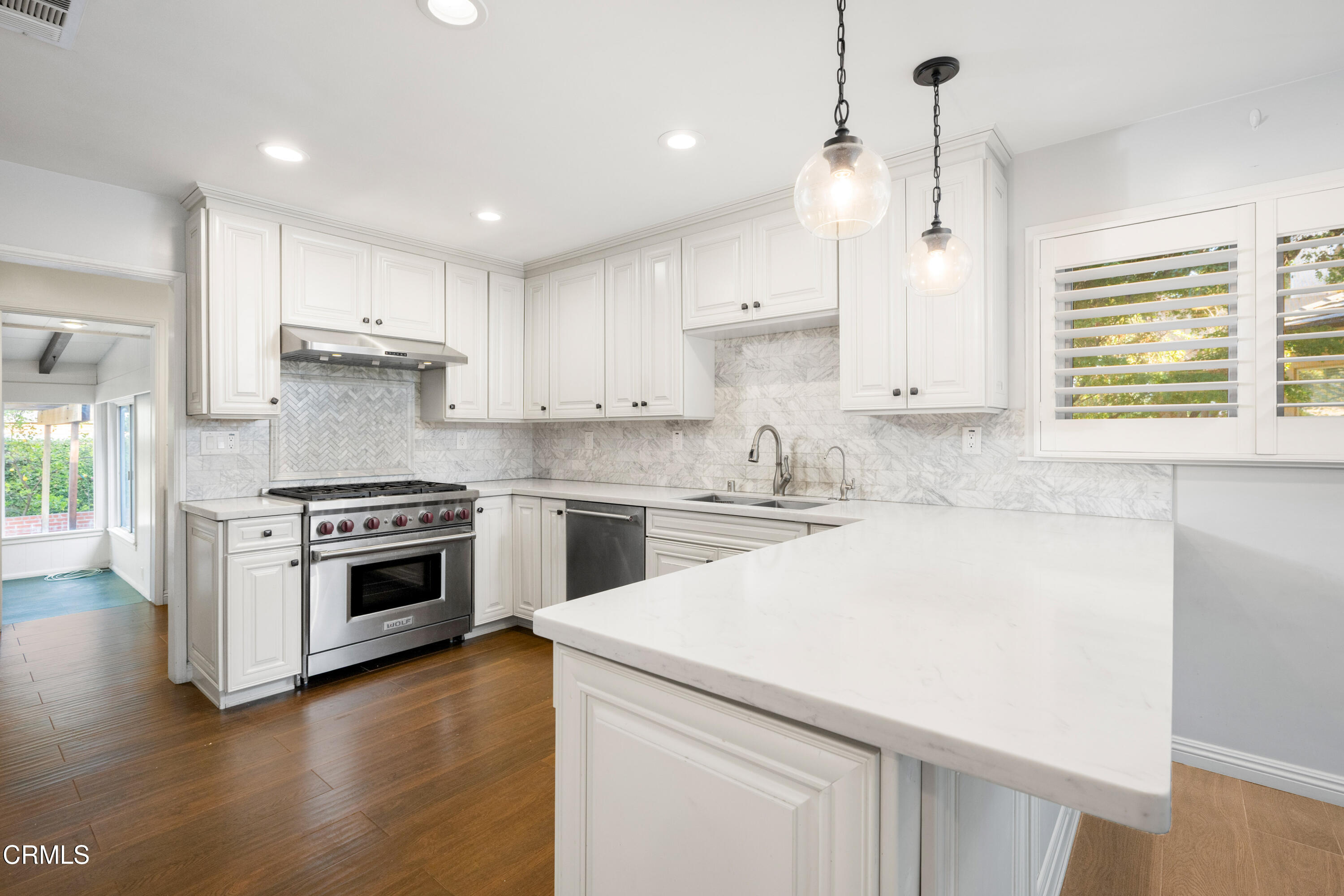 a kitchen with a white stove top oven and white cabinets