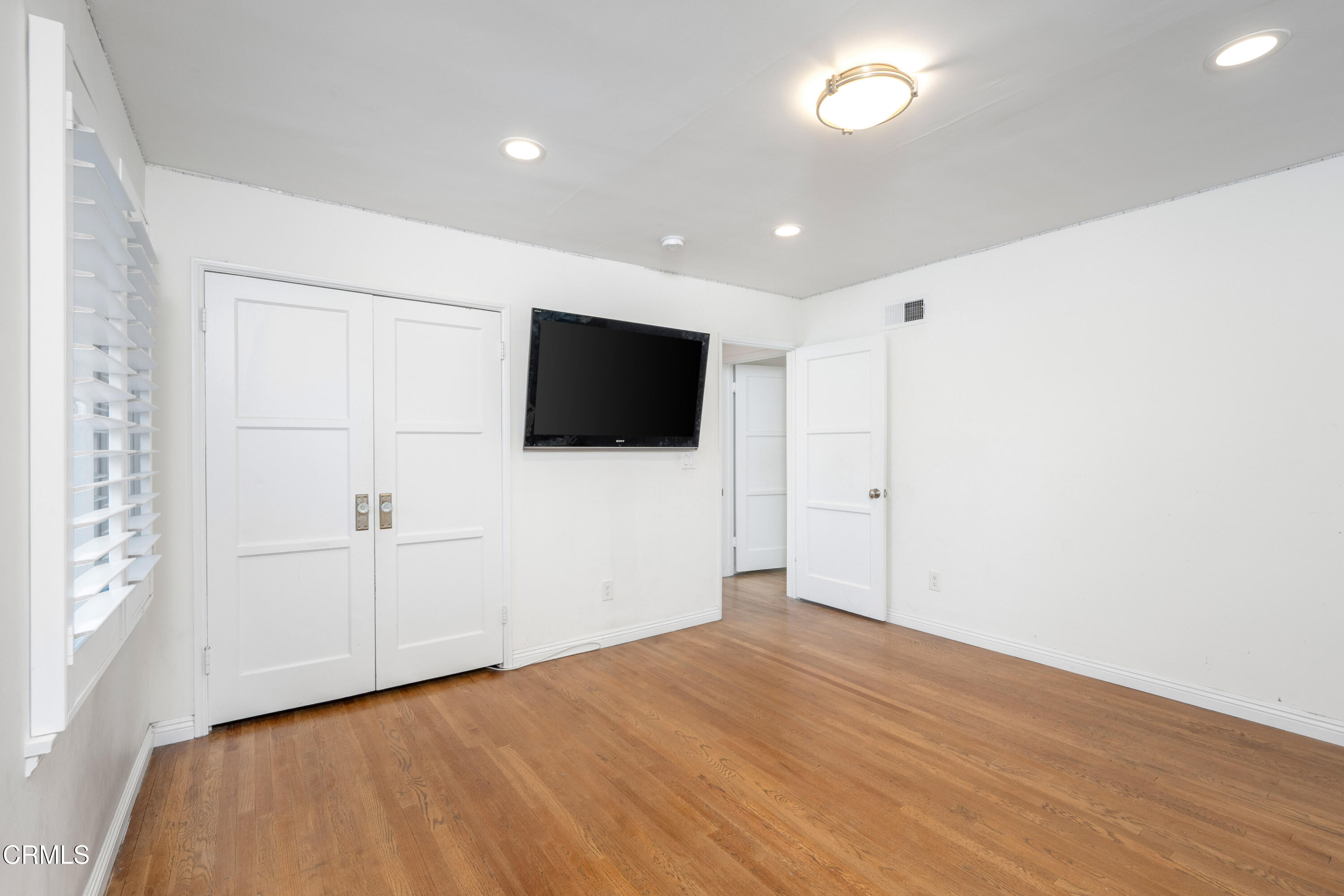 1626 Rodeo Road Arcadia, CA 91006 - Photo 18 of 25 a view of empty room with wooden floor and windows