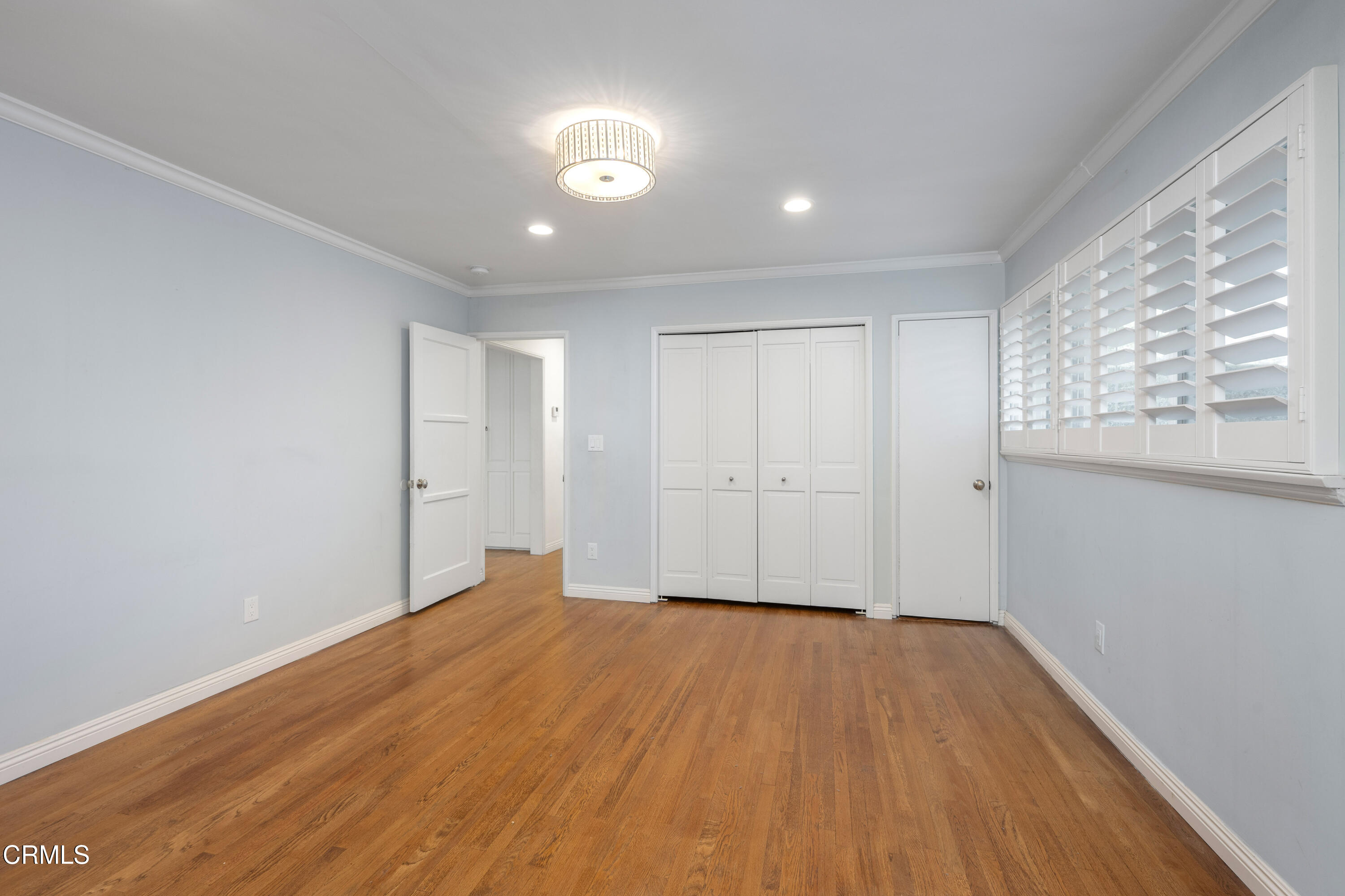 1626 Rodeo Road Arcadia, CA 91006 - Photo 19 of 25 a view of an empty room with wooden floor and a window