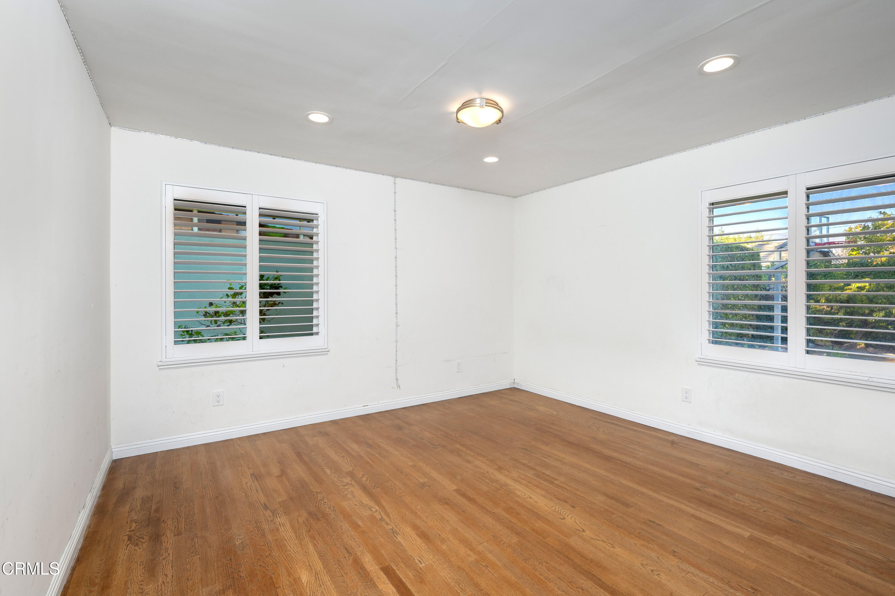 1626 Rodeo Road Arcadia, CA 91006 - Photo 23 of 25 a view of an empty room with wooden floor and a window