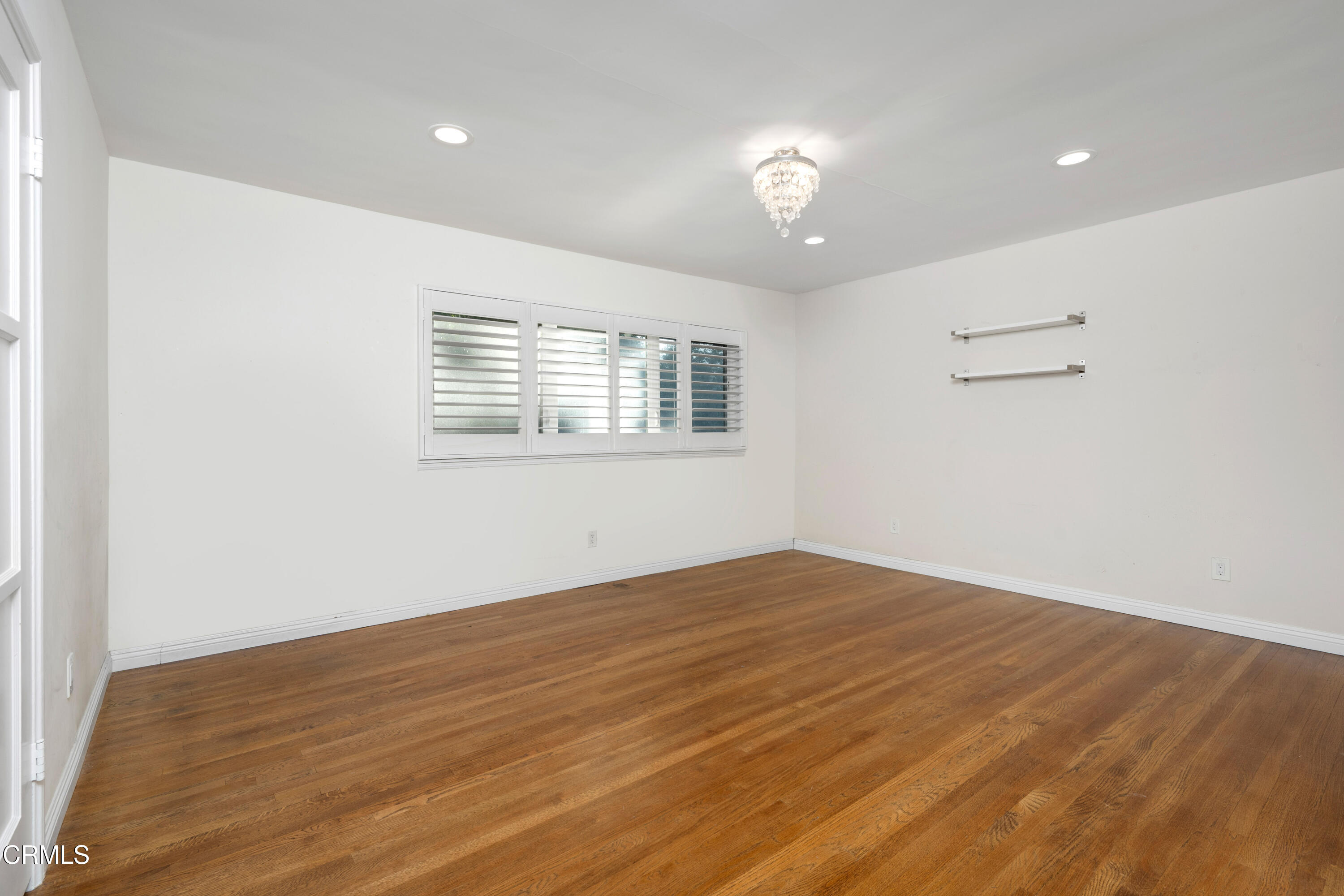 1626 Rodeo Road Arcadia, CA 91006 - Photo 24 of 25 an empty room with wooden floor and windows