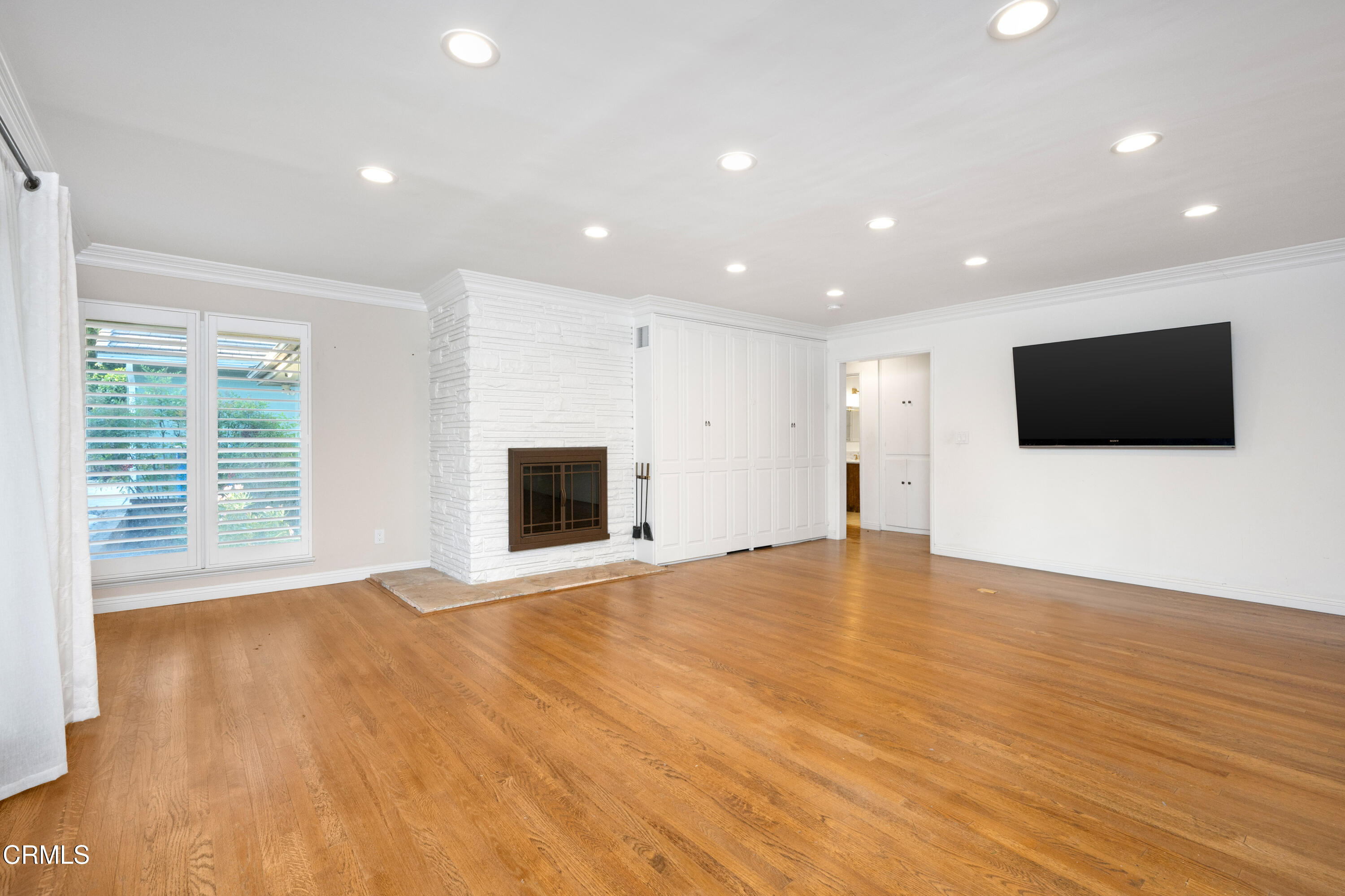 1626 Rodeo Road Arcadia, CA 91006 - Photo 10 of 25 a view of an empty room with wooden floor and a flat screen tv