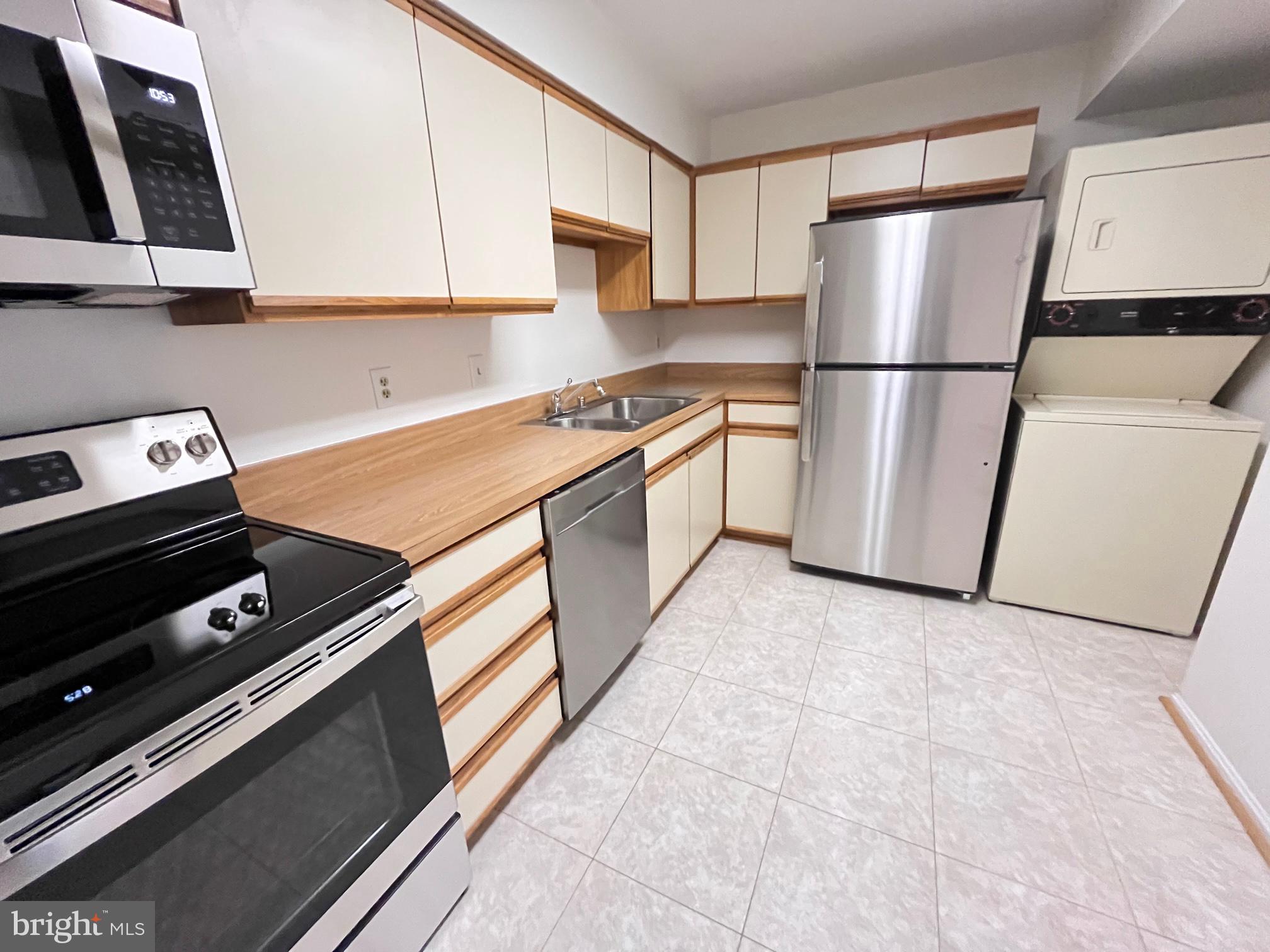 15100 Interlachen Drive, Unit 815 Silver Spring, MD 20906 - Photo 8 of 26 Stacked Washer/Dryer in kitchen