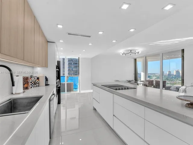 a kitchen with stainless steel appliances granite countertop a sink a stove and a wooden cabinets