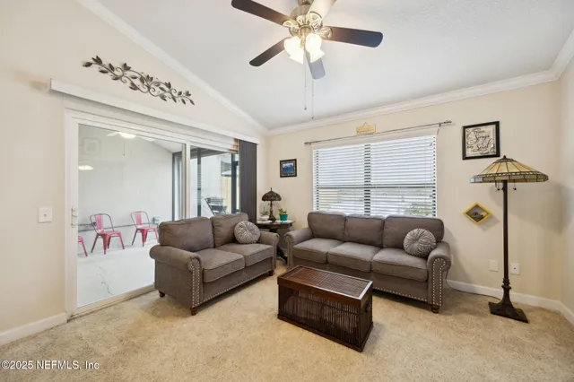 a spacious bedroom with a bed and a chandelier