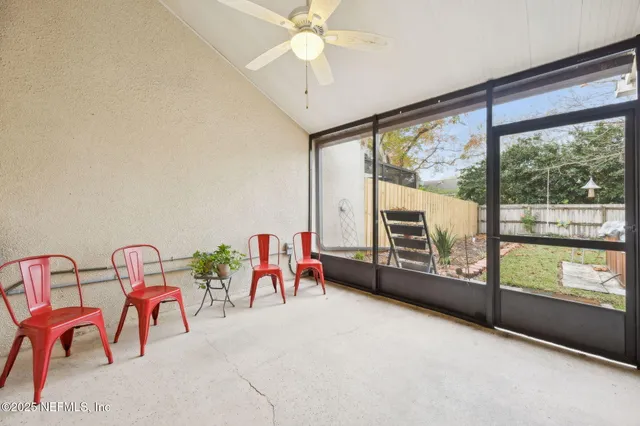 a view of a livingroom with furniture and a floor to ceiling window