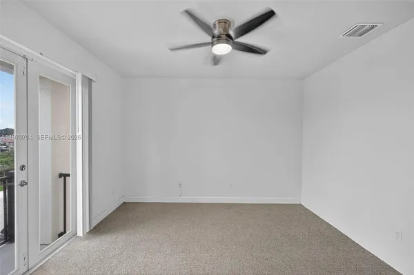 an empty room with a empty space and a ceiling fan