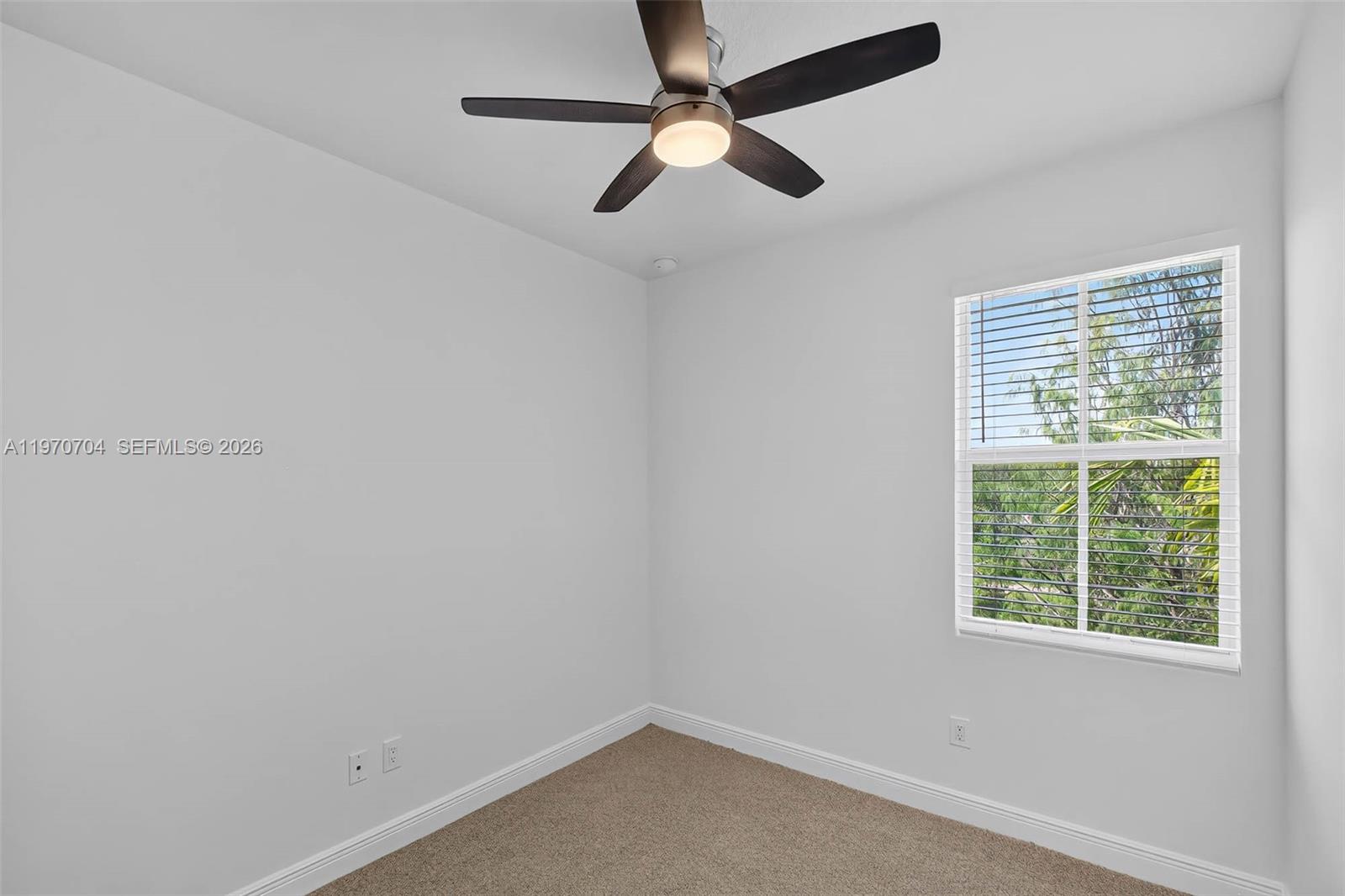 7651 North Pine Island Road Tamarac, FL 33321 - Photo 6 of 9 an empty room with a window