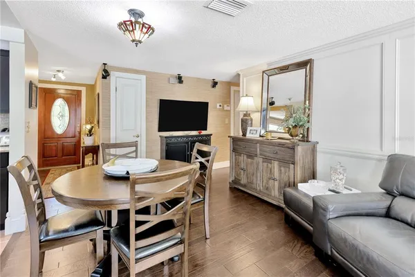 a view of a dining room with furniture and a chandelier