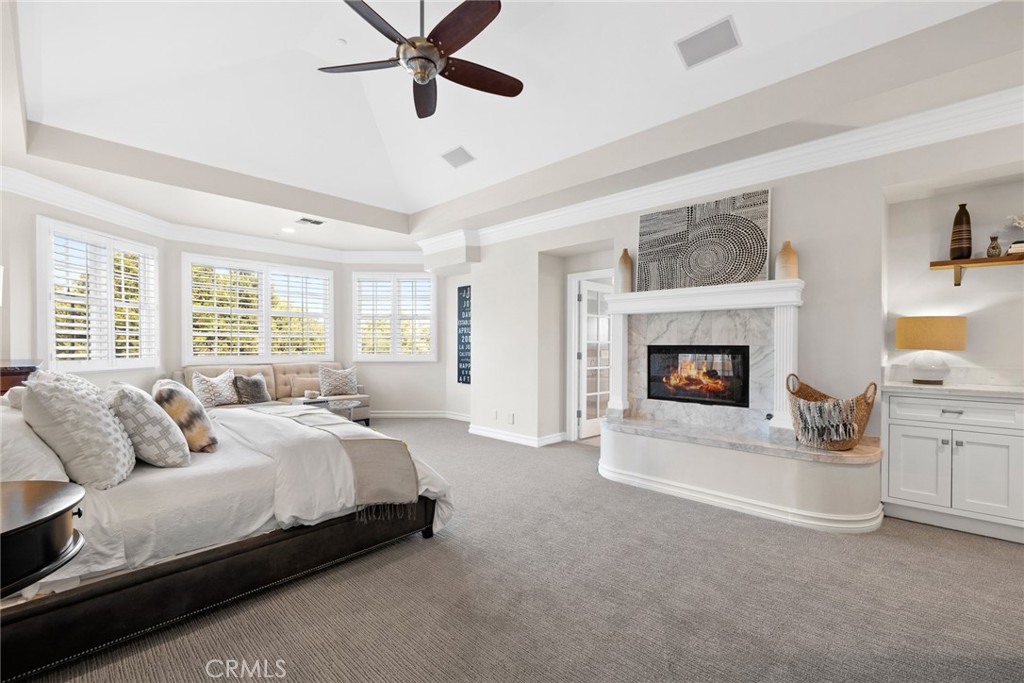 4 Percheron Coto de Caza, CA 92679 - Photo 15 of 44 a spacious bedroom with a bed and a fireplace
