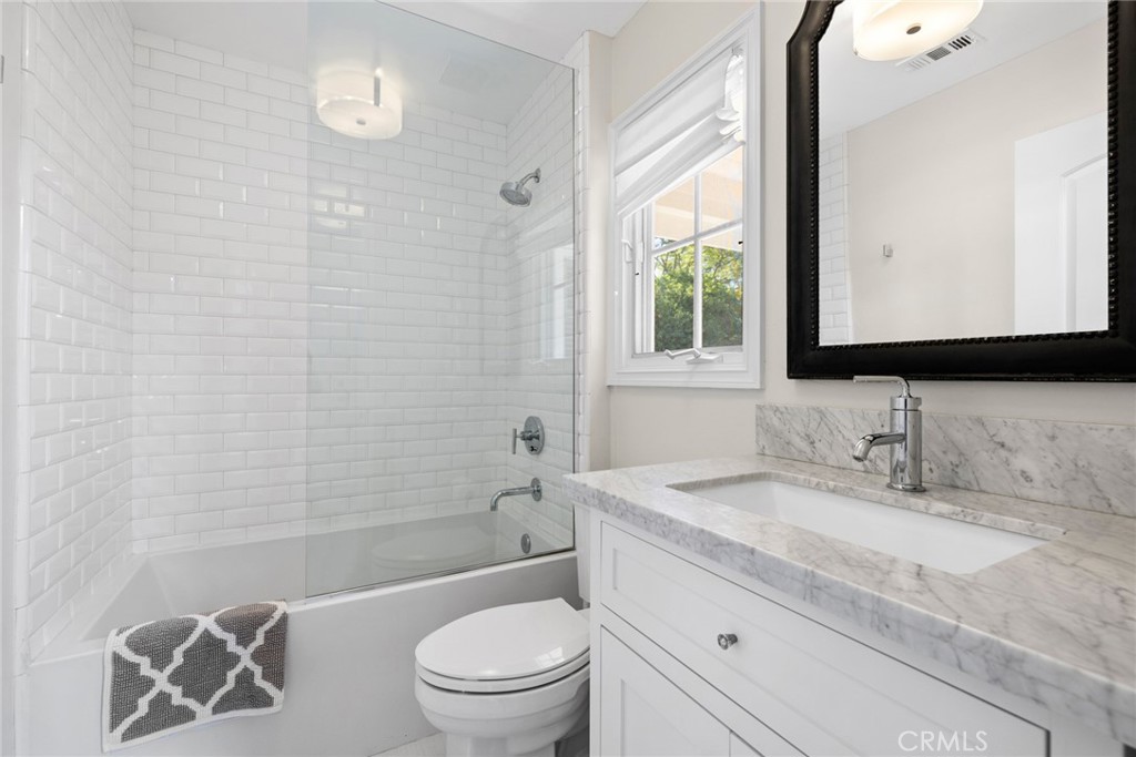 4 Percheron Coto de Caza, CA 92679 - Photo 28 of 44 a bathroom with a granite countertop sink toilet mirror and shower